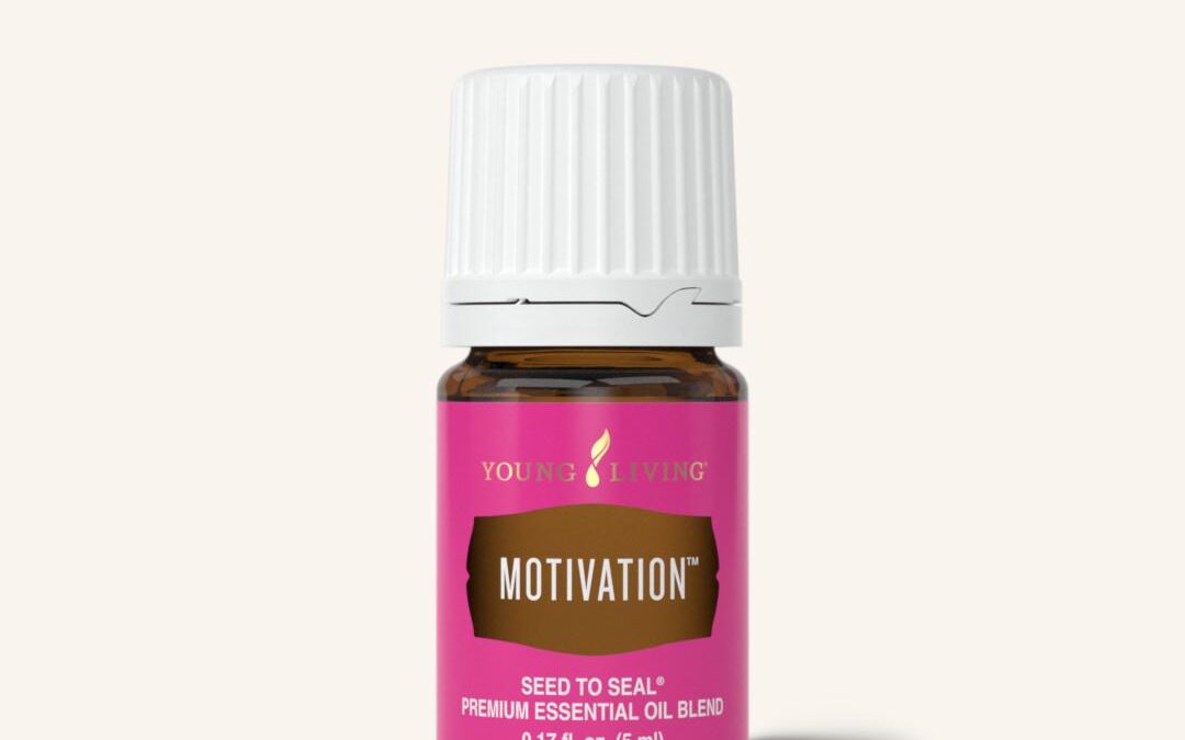 A brown bottle of Motivation essential oil with a bright pink label and white lid.
