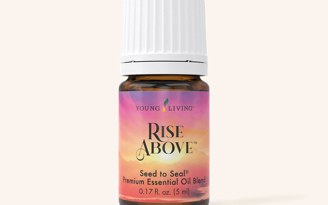 A brown bottle of Young Living's Rise Above essential oil with a pink and orange sunset image and a white lid.