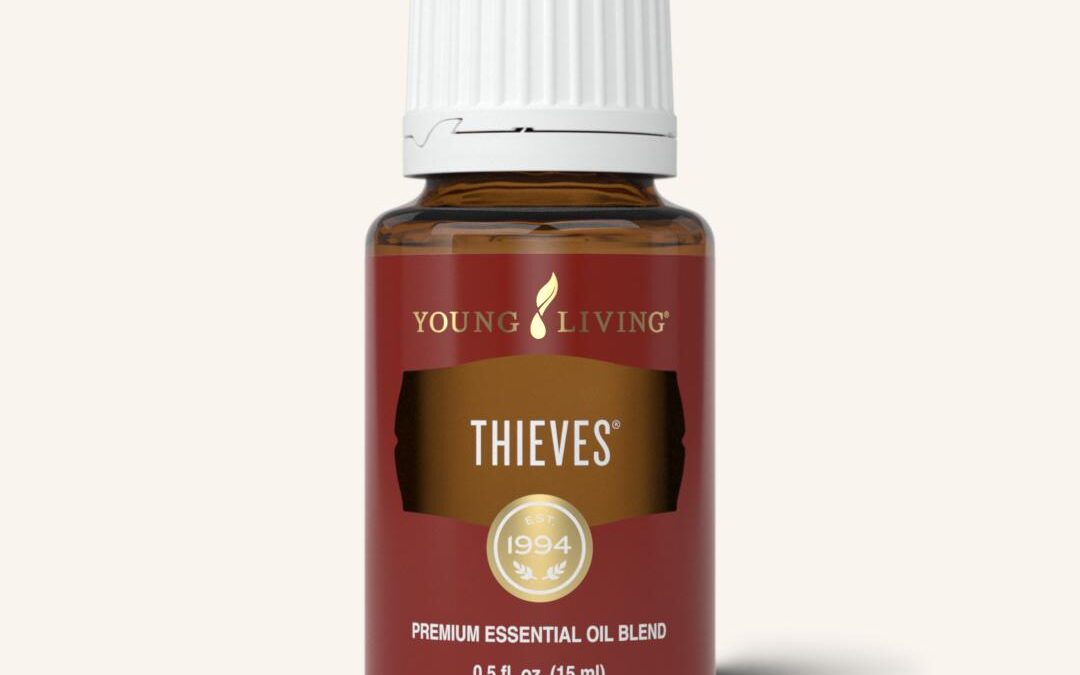 Brown bottle of Young Living's Thieves essential oil with a white lid and burgundy and gold label.