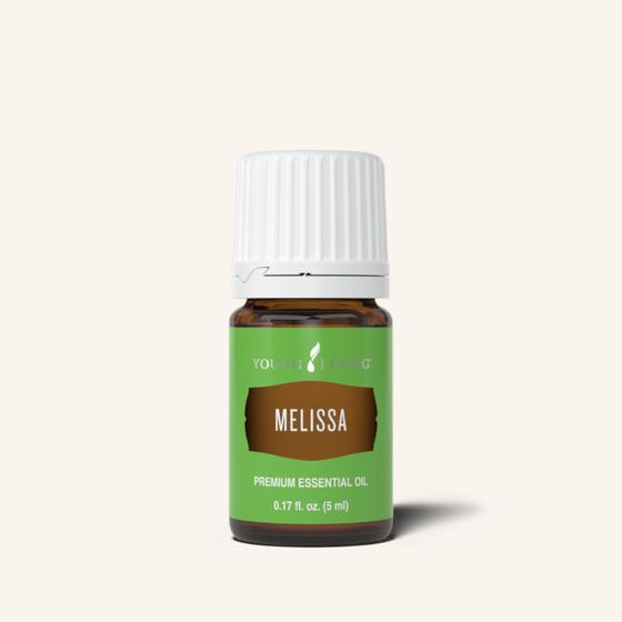 A small brown bottle of Melissa Young Living essential oil with a white cap and bright green label.