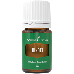 Brown bottle of essential oil with a green label and white cap